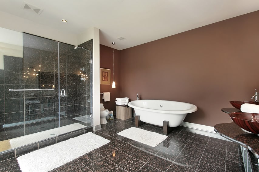 Bathroom uses 30x30 polished porcelain tiles in a natural stone finish