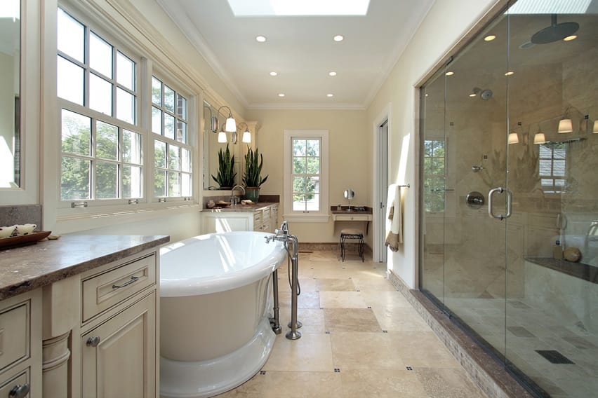 Country inspired bathroom design with pedestal tub and large rainfall shower