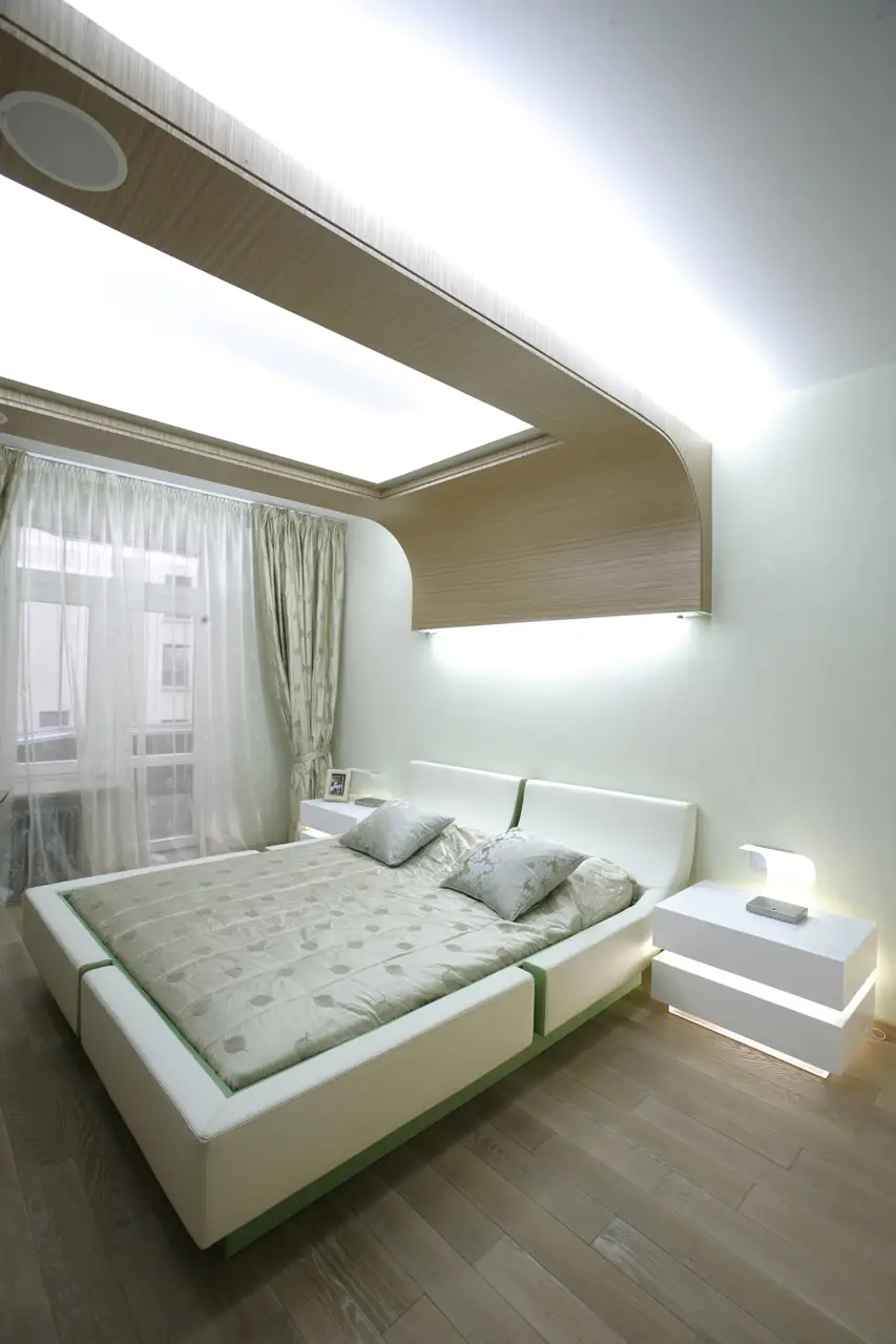 Bedroom with laminate accent on the ceiling and green bed