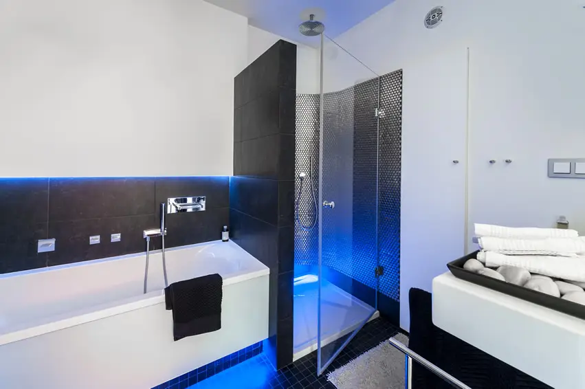 Shower area with metallic mosaic tiles and blue lighting
