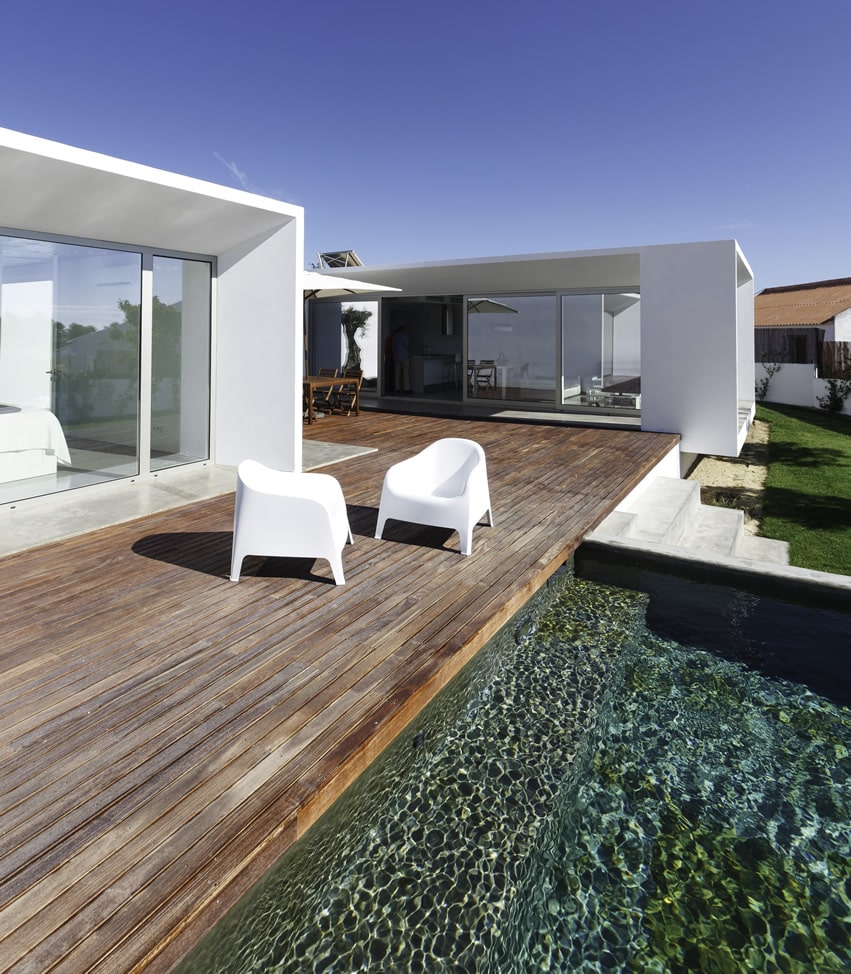 Modern home with wooden deck and pool