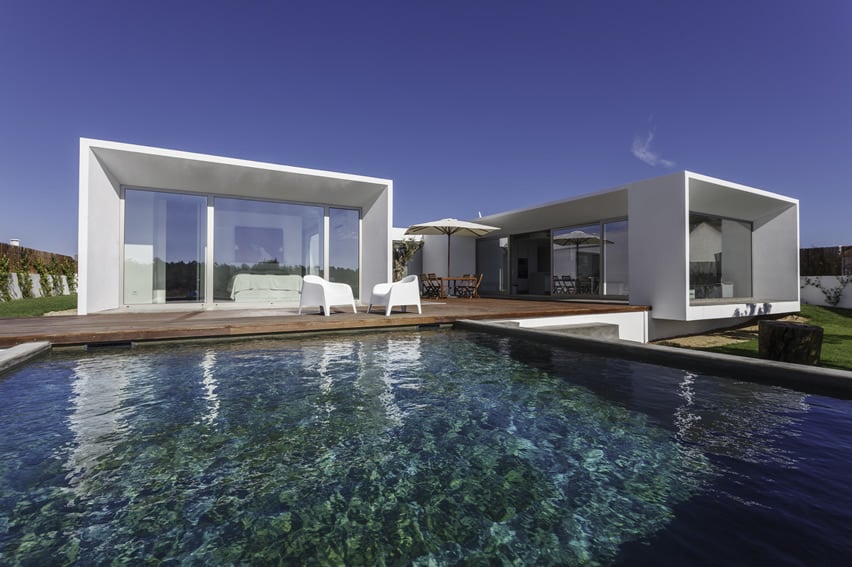 Pool with dark green tiles with poured concrere sides