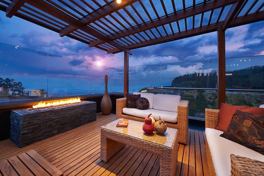 Modern propane fire pit on deck with lounge chairs