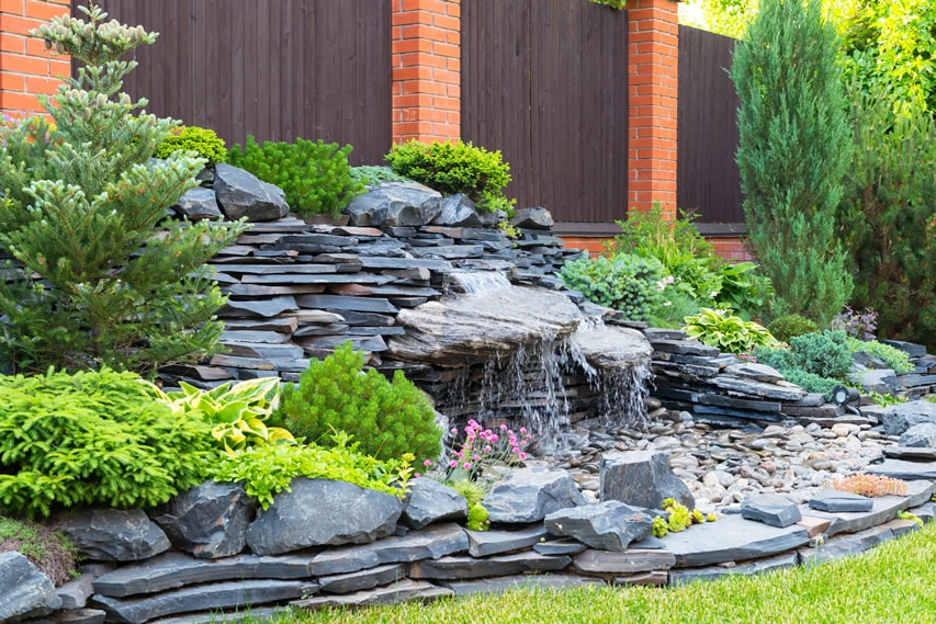 Natural backyard landscaping with trickling water