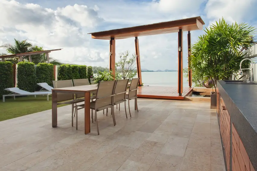 Patio with lake view, gazebo, kitchen and dining space