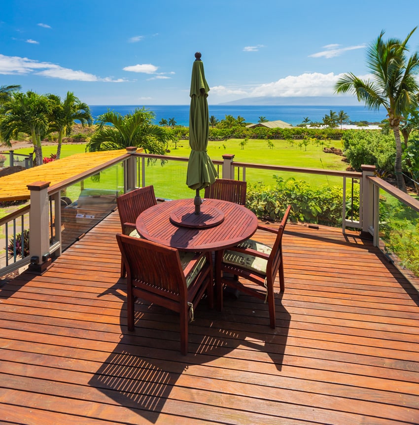 Outdoor dining table on deck with ocean view