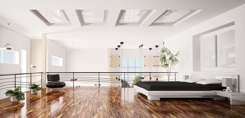 Loft bedroom with glass ceiling treatment, black chair and windows