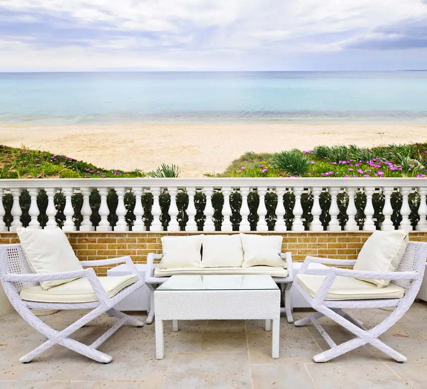 Patio with beach view and white furniture