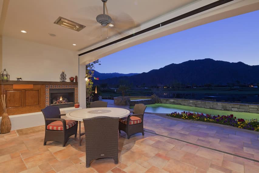 Patio with ceramic stone tile floors overlooking pool and mountains