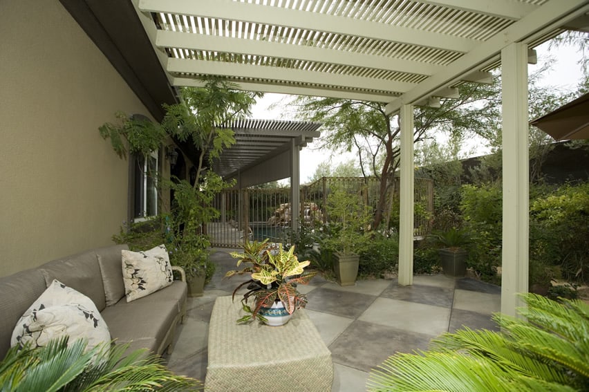 Garden patio area with white pergola and outdoor furniture