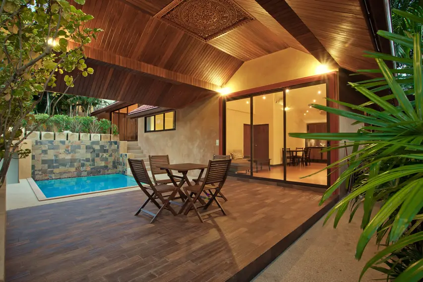 Asian-inspired patio with solid wood floors in dark mahogany and small pool