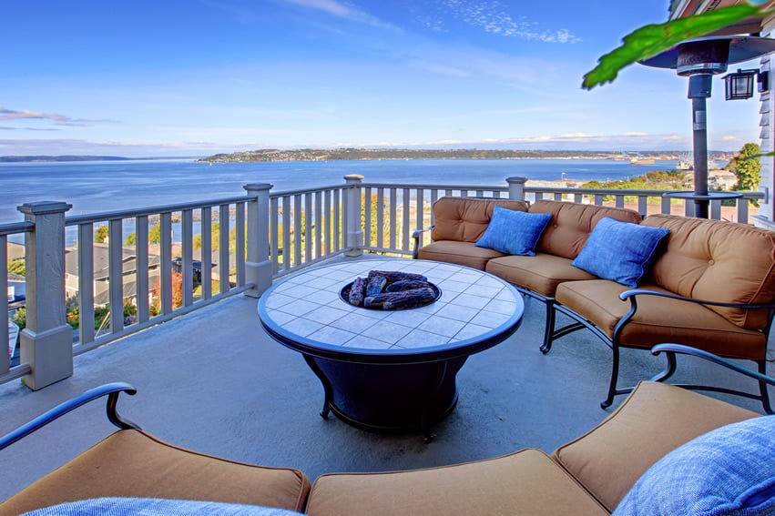 Country-inspired balcony patio with amazing view of the ocean and fire pit