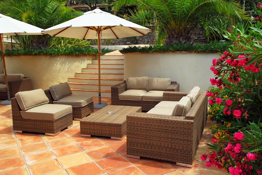 Spanish style patio with 30x30 terracotta pavement tiles and flowering plants