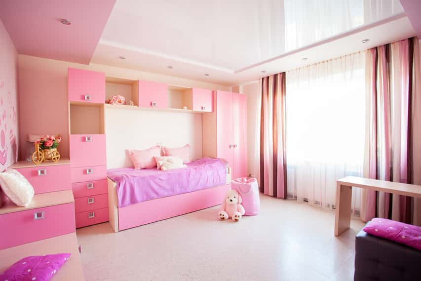 Room with pink cabinets, pink panel curtains and stacked drawer set