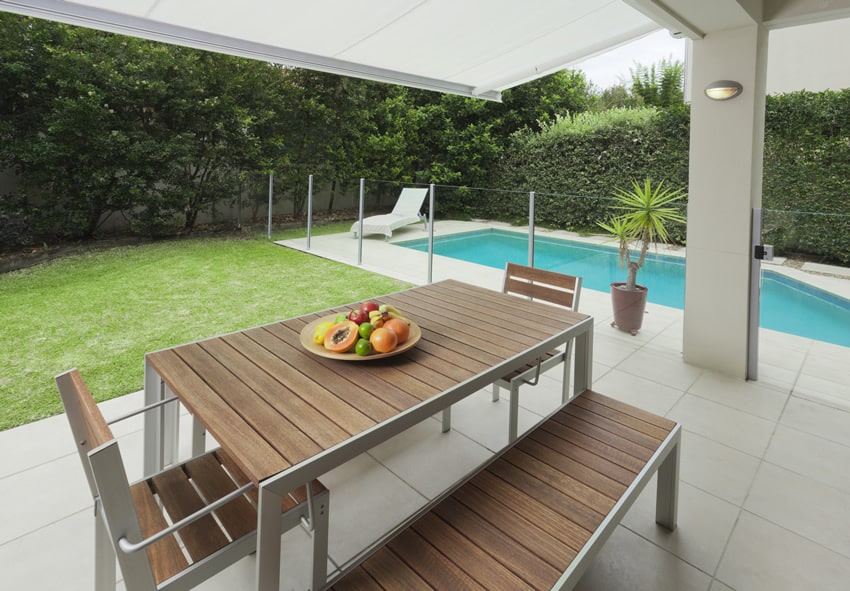 Modern pool-side patio design with outdoor dining table