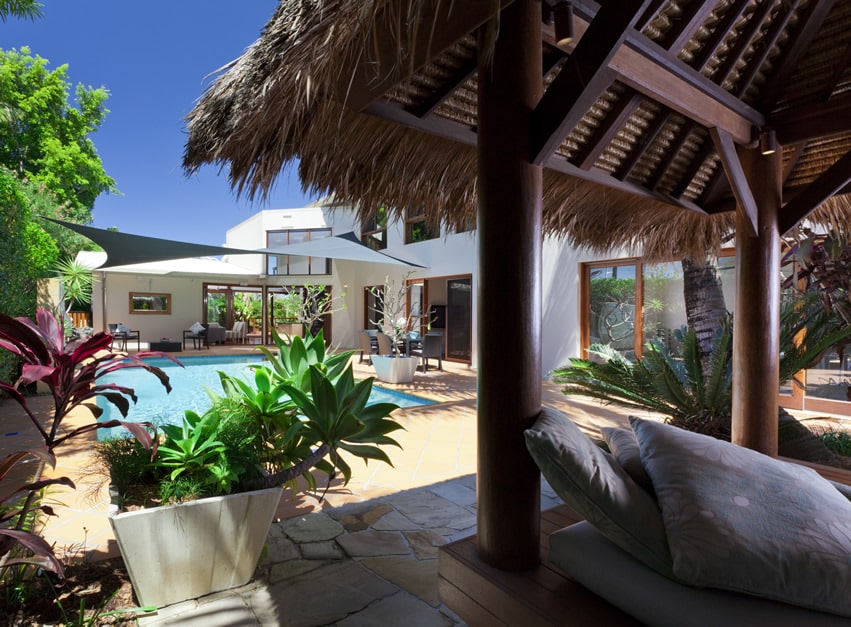 Pool-size gazebo with tropical setting