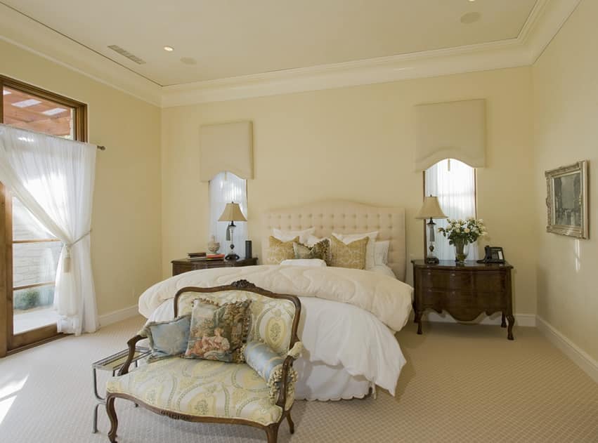 pretty master bedroom with yellow walls traditional furnishings