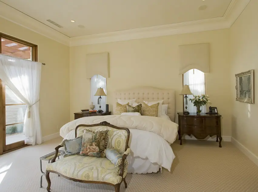 Pretty master bedroom with yellow walls traditional furnishings