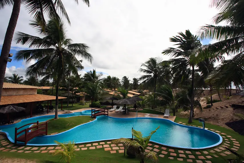 Curvy pool with terracotta tile pathway