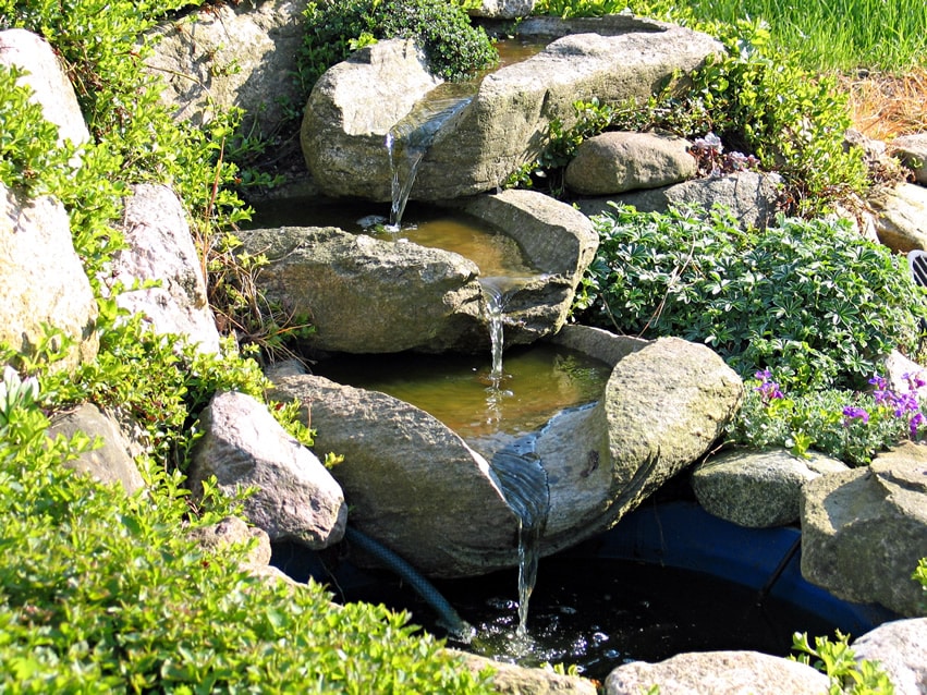 Small stone stream waterfall in garden