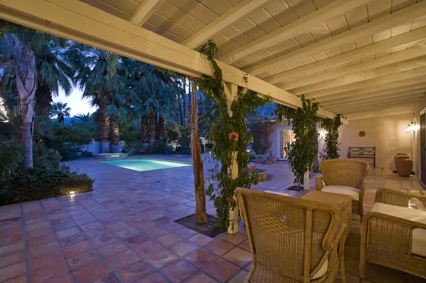 Patio with Spanish style terra cotta red paving tiles and creeping vines