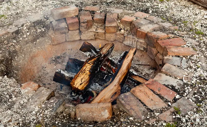 Sunken brick fire pit in backyard