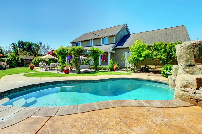 Pool with cut stone pathway and accentuated with large stones