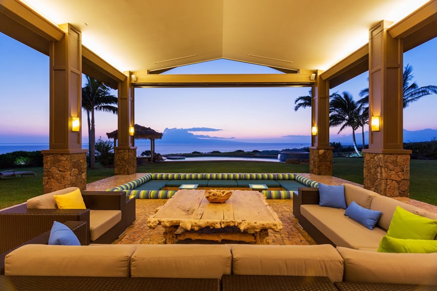 Tropical home with covered patio using faux masonry tiles with amazing ocean view