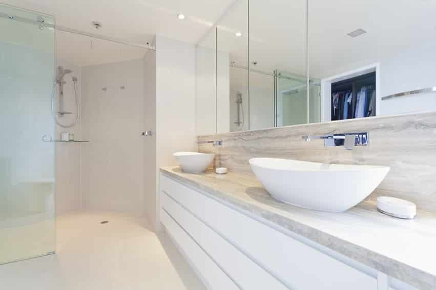White bathroom with Danby marble splashboard with vessel sinks