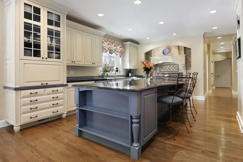 Kitchen with gray painted island with open shelving