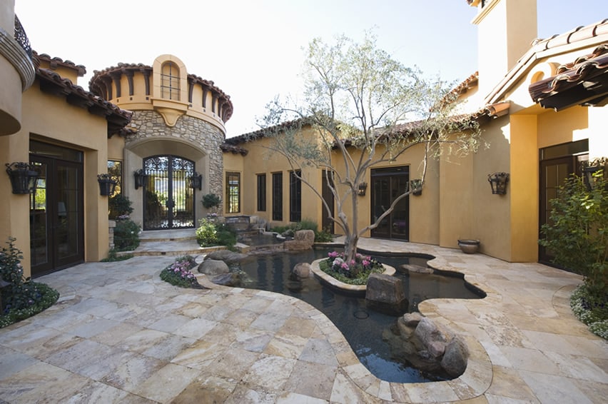 Patio water feature pond with fountain in courtyard of luxury house