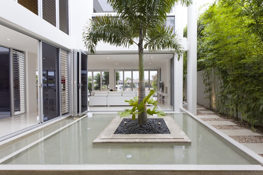 Pool feature in modern home with island tree