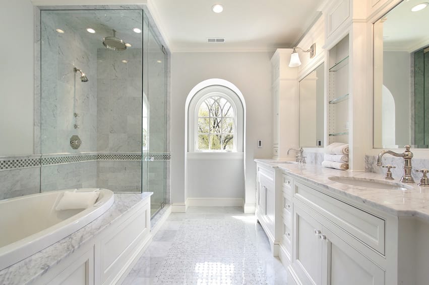 Bathroom with round-edged bathtub, a walk-in-shower and arched window