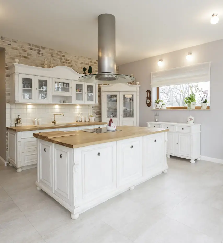 Kitchen with wood island, porcelain floor tiles and faux brick wallpaper