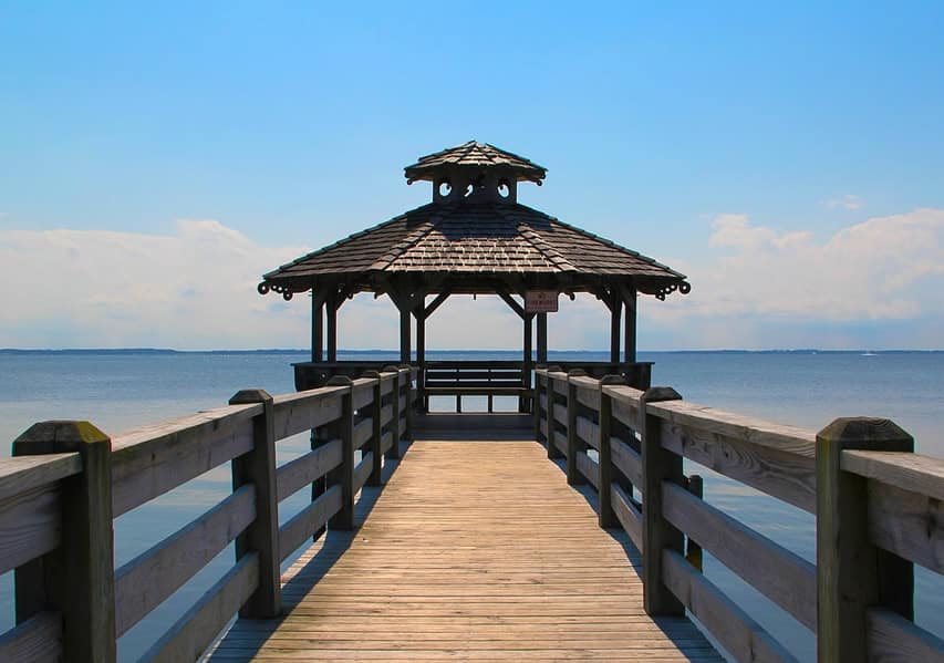 Wood gazebo at end of dock on lake