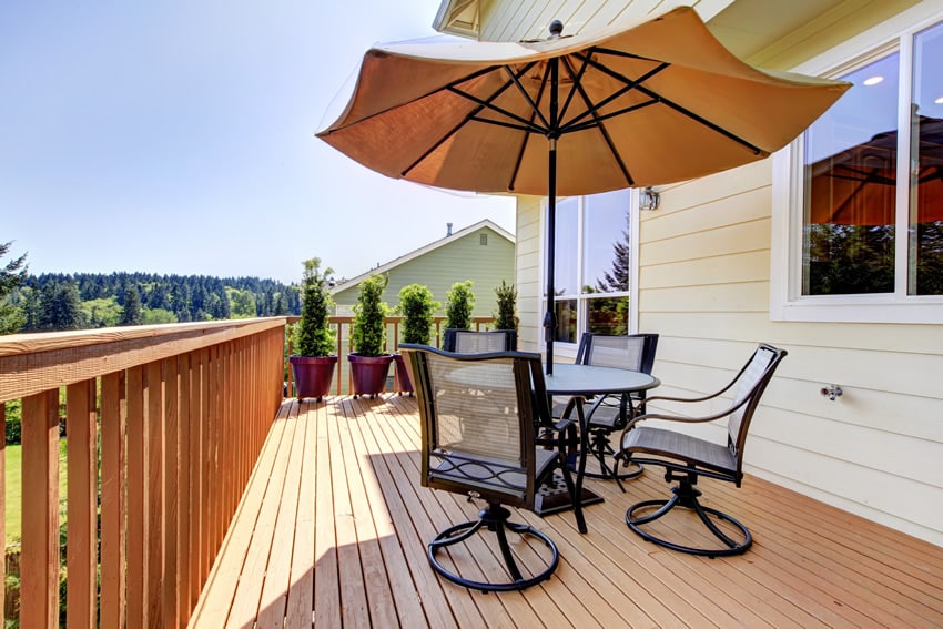 Wooden backyard deck with table and umbrella