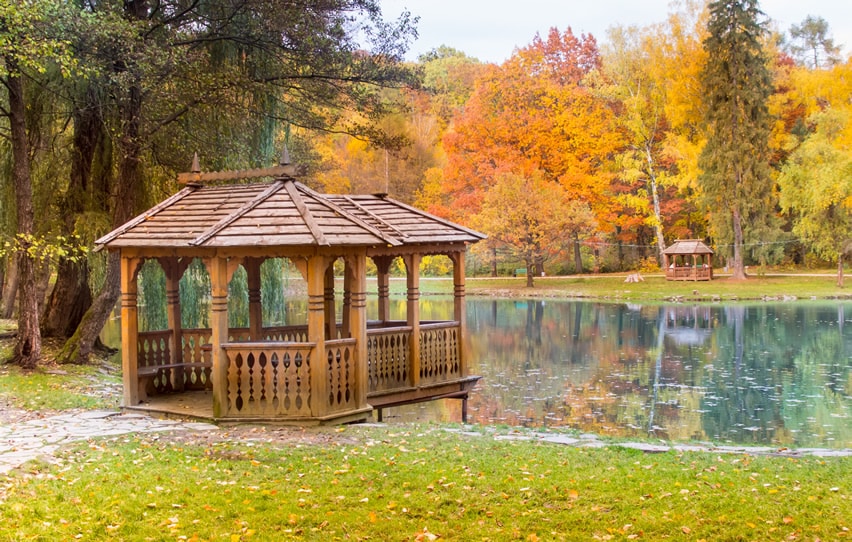 Two wooden gazebos on lake