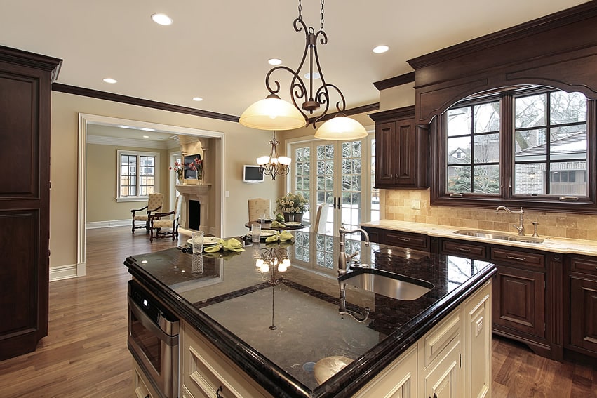 Kitchen with sandstone backsplash and square island with soft edges