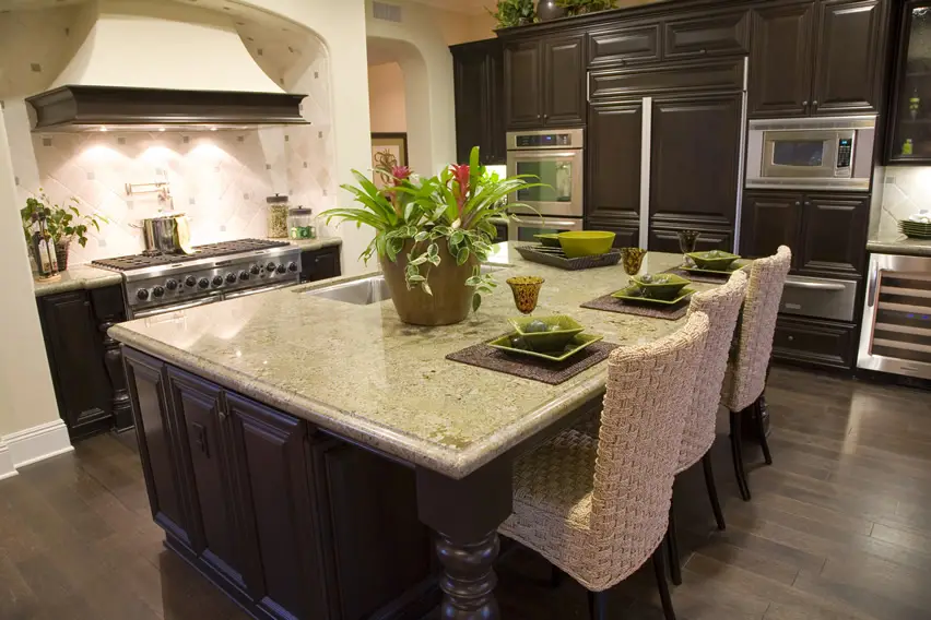 Dark wood cabinet luxury kitchen with large granite dining island