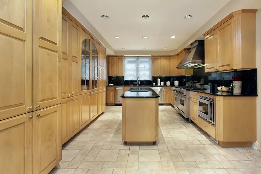 Kitchen in light color oak laminated cabinets and splashboard