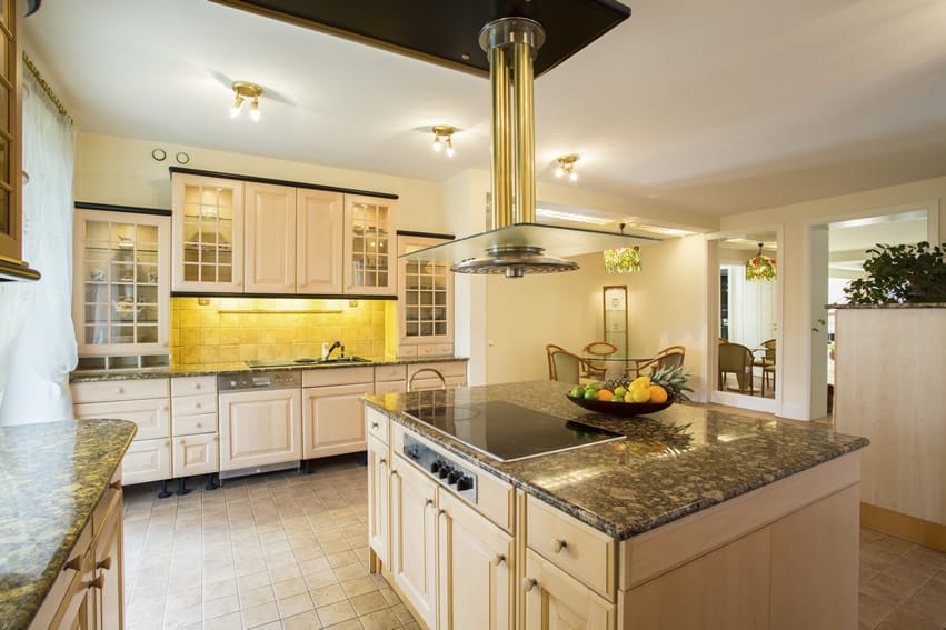 Granite counter kitchen with center island brass glass range hood