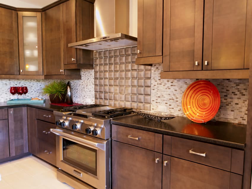 Kitchen with stone mosaic tiles and cabinets with satin finish wengue color