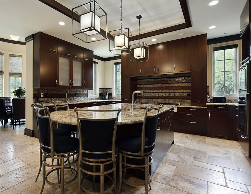 Kitchen with dark cabinetry with rounded island
