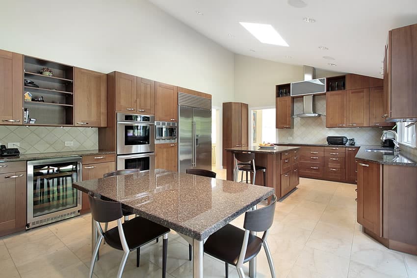 Kitchen with granite island and table in upscale home