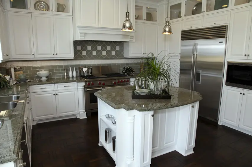 Kitchen with white cabinetry stainless fixtures
