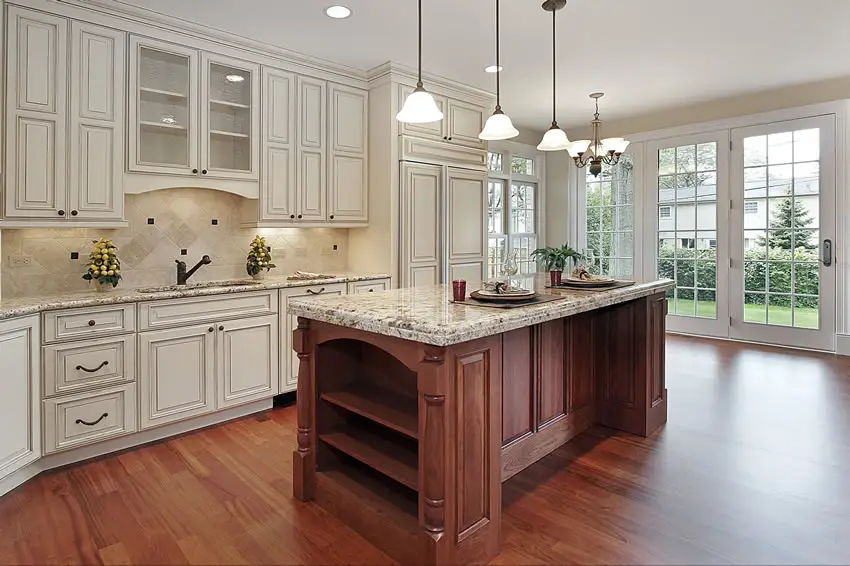 Kitchen with white cabinets wood island