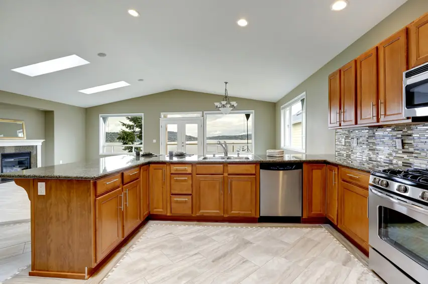 Lake view from u-shaped kitchen with tile back splash