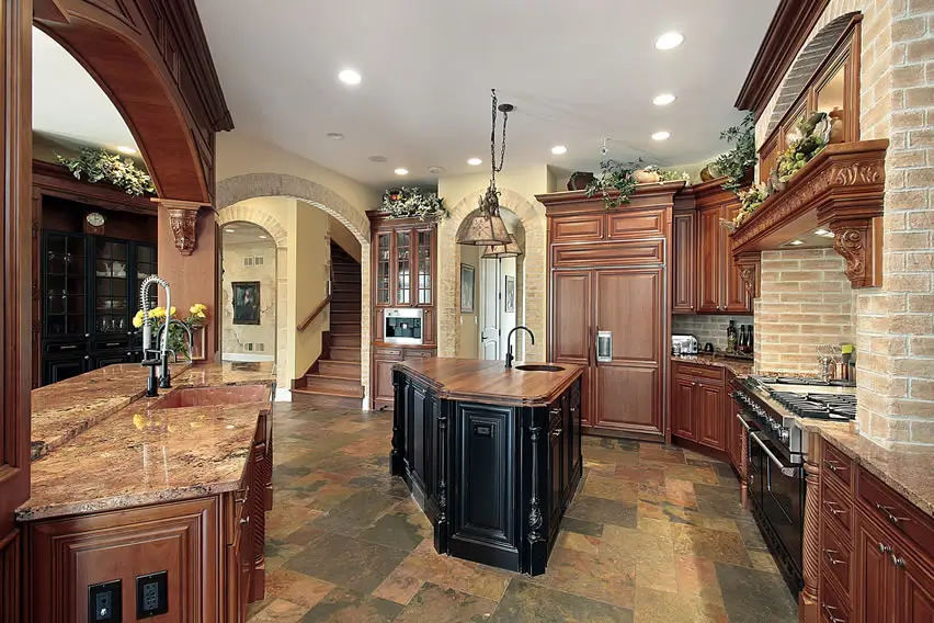 Upscale kitchen with island brick accent wall