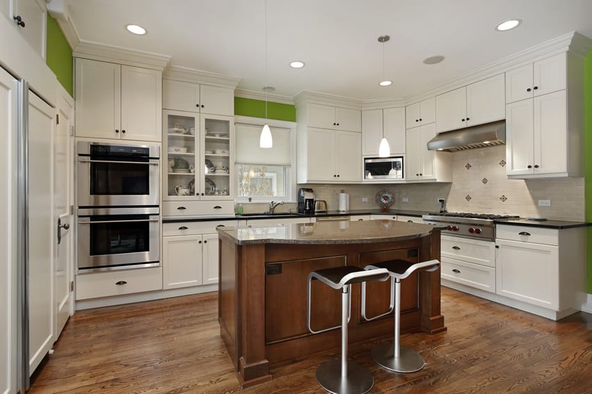 White kitchen cabinets with bright green walls