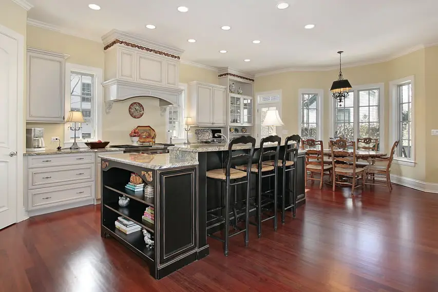 White kitchen with dark island painted yellow room